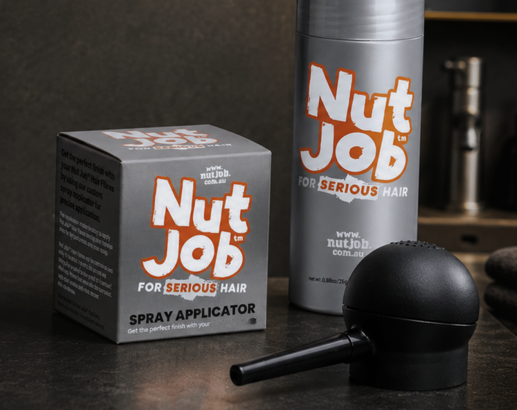 Close-up of the Nut Job spray applicator box beside a hair fibres bottle and the black applicator pump